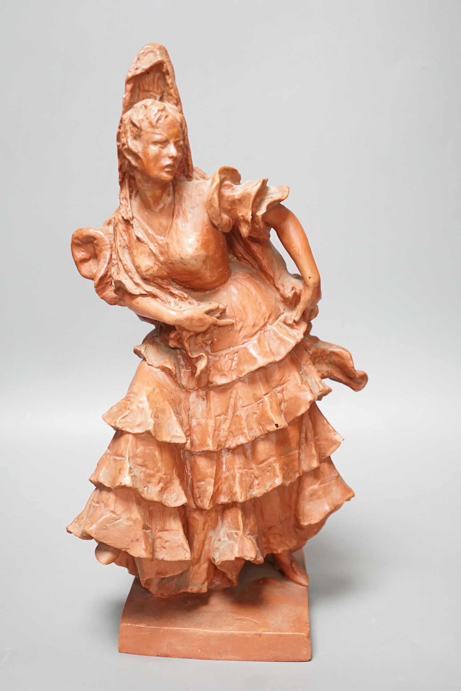 A red composition figure of a Spanish dancer, indistinctly signed to reverse, 34cm tall